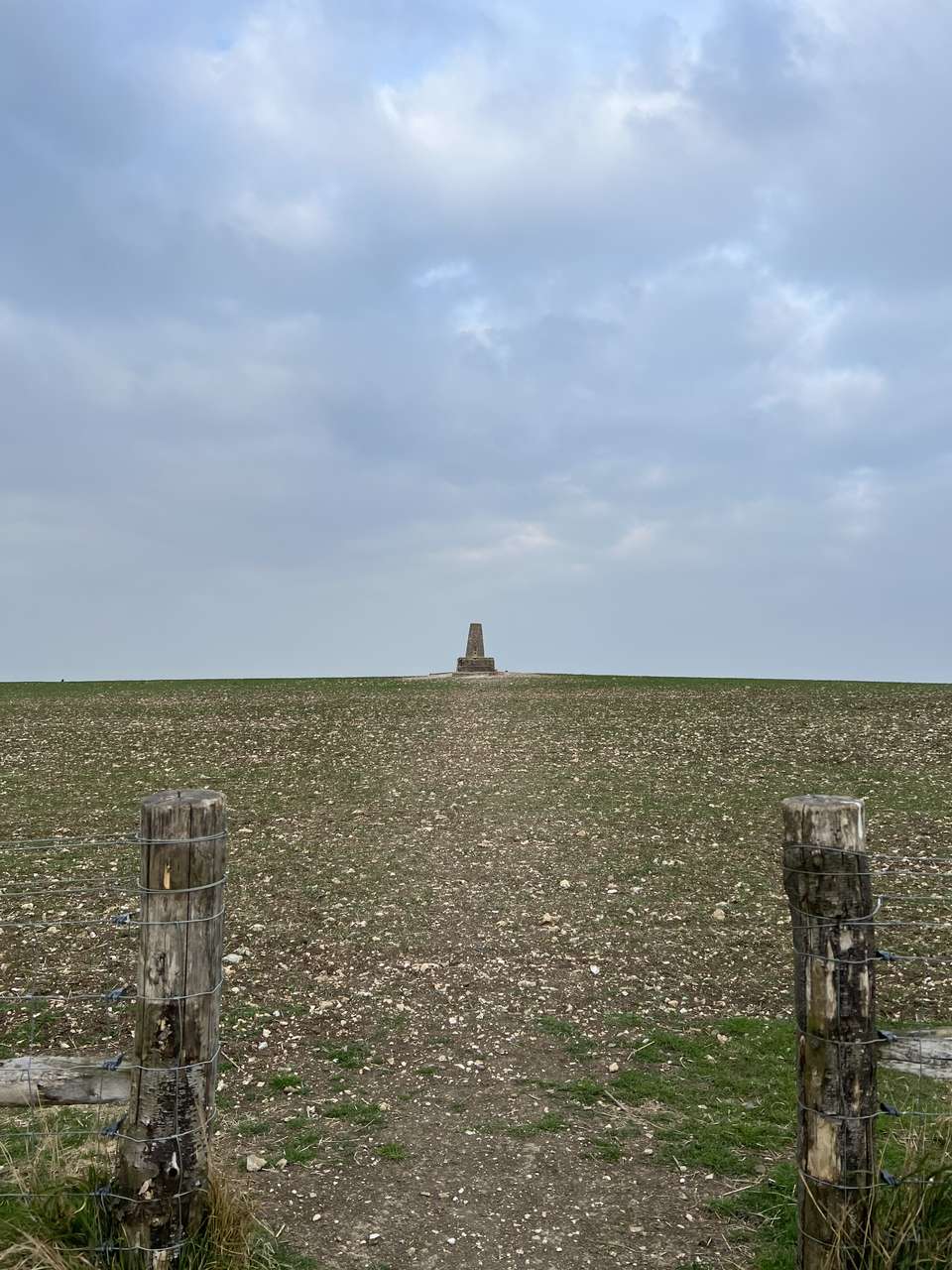 The trig point at Warden Hill sits in farm field